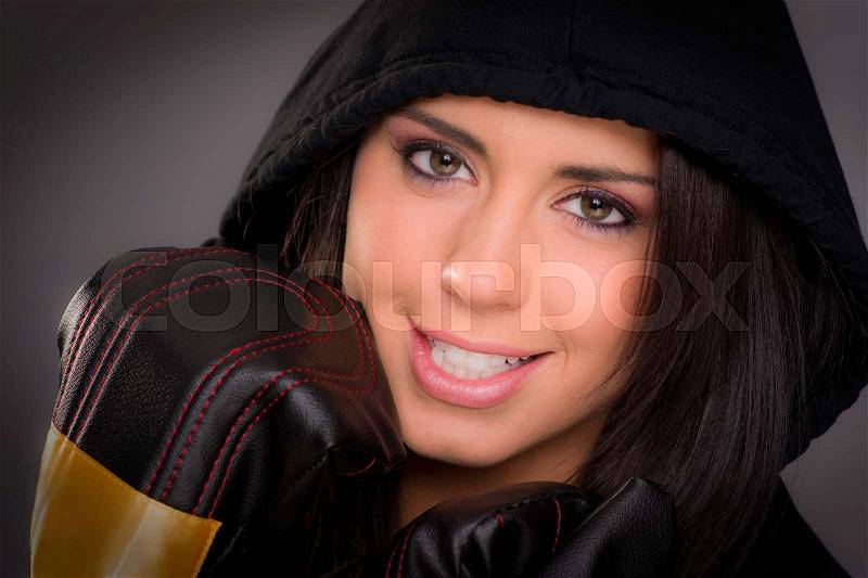 Beautiful Boxer Female in Black Hoodie Wearing Practice Gloves, stock photo