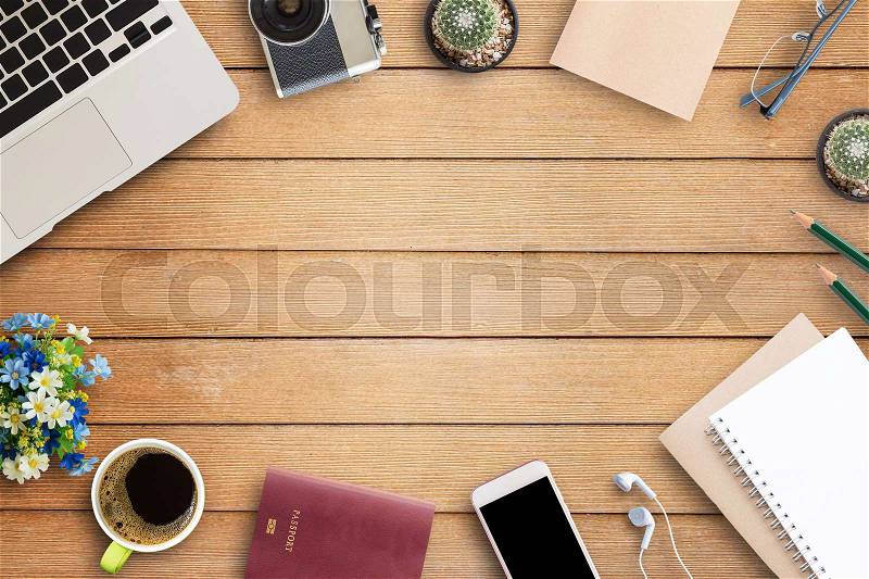 Office desk table with office equipment,laptop computer, glasses, smart phone, cup of coffee and flower on wooden table background. Top view with copy space (selective focus), stock photo
