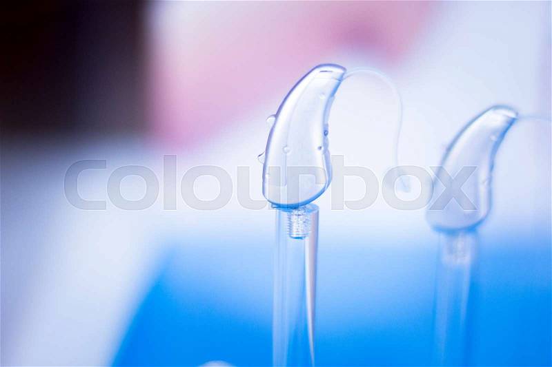 Modern high technology digital hearing aids in retail store shop window for the deaf and hard of hearing, stock photo