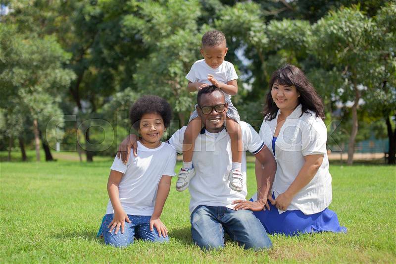 Happy diverse and mixed race family group photo in the park, stock photo