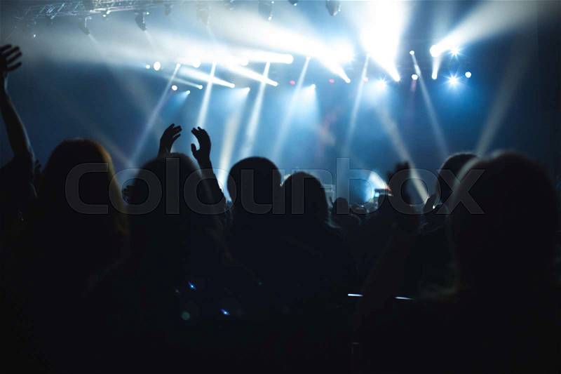 The audience watching the concert on stage, stock photo