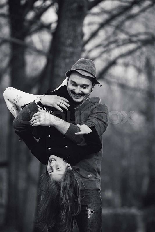 Dad holding his daughter upside down on his hands, stock photo