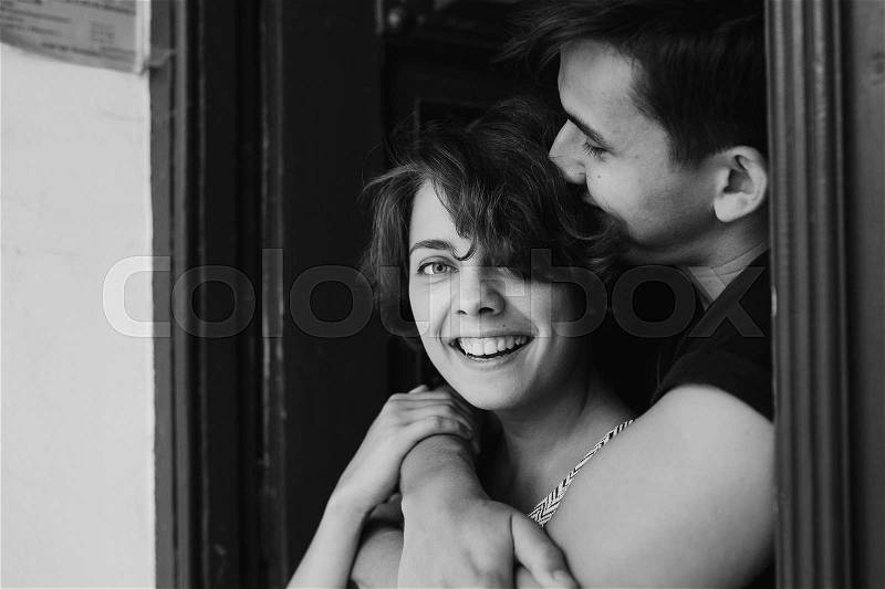 Couple posing in the doorway posing on camera, stock photo