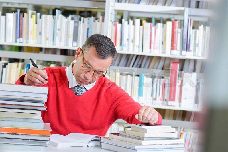 Busy reader in the library, stock photo
