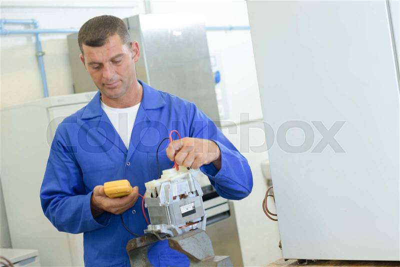 Industrial technician reading a voltmeter, stock photo