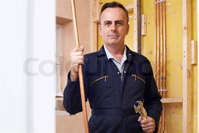 Portrait Of Male Plumber Working In House, stock photo