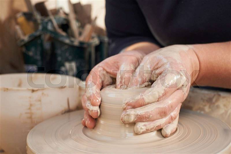 Close Up Of Potter Moulding Clay On Wheel, stock photo