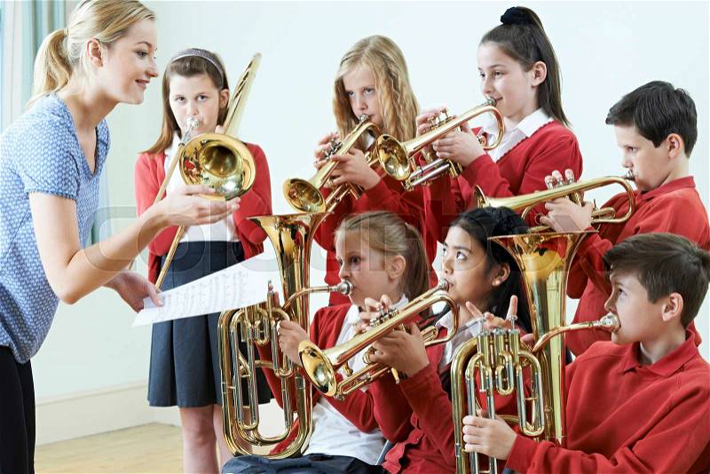 Group Of Students Playing In School Orchestra Together, stock photo