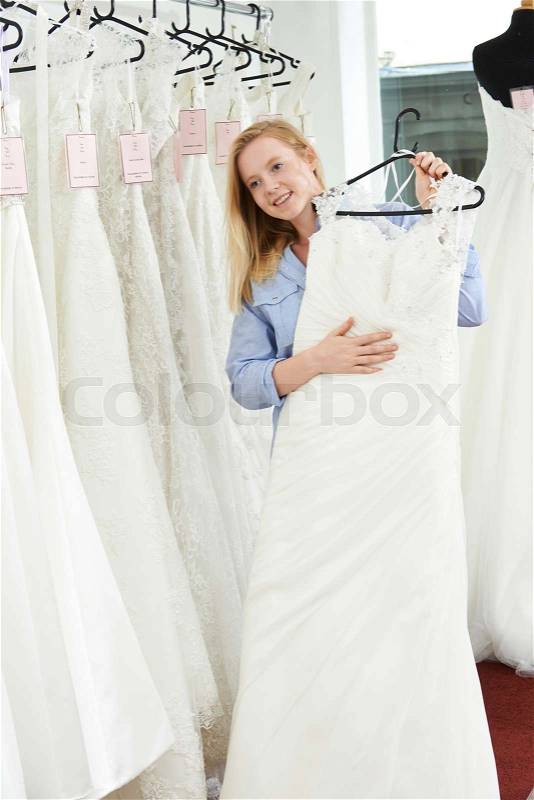 Bride Choosing Dress In Bridal Boutique, stock photo