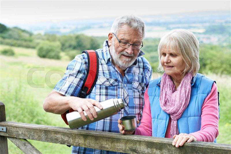 Senior Couple On Hike Having Hot Drink, stock photo