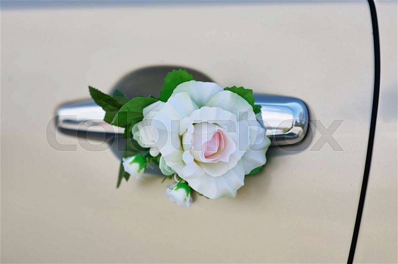 White rose flower on the handle of a car in wedding day, stock photo