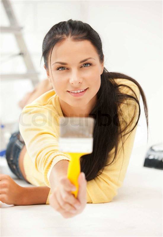 Bright picture of lovely housewife painting at home, stock photo