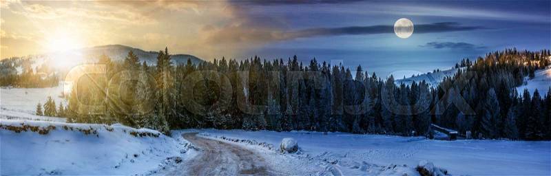 Day and night time conept of panoramic mountain landscape in winter. winding road that leads into the spruce forest on a snowy meadow with sun and fool moon, stock photo