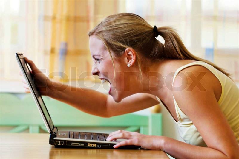 A woman angry over your computer Problems with hardware, software and Internet shopping, stock photo