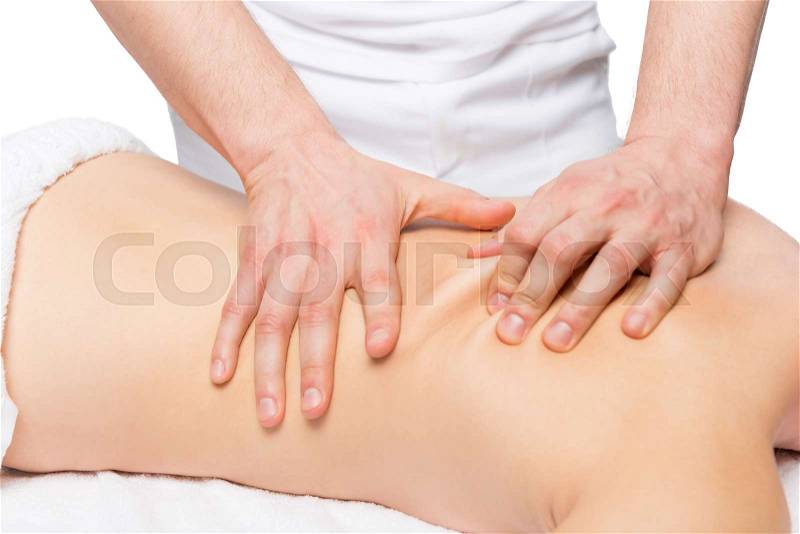 Male masseur does back massage on a massage table, stock photo