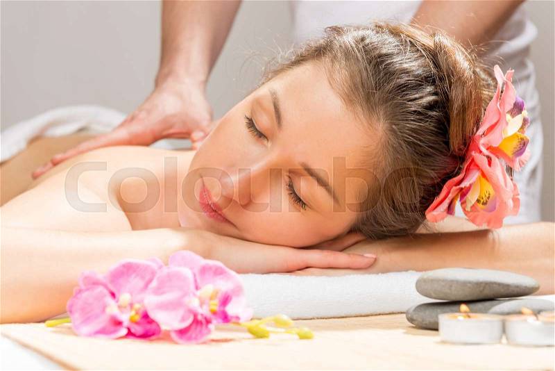 Woman enjoys the spa cabinet during the massage, stock photo