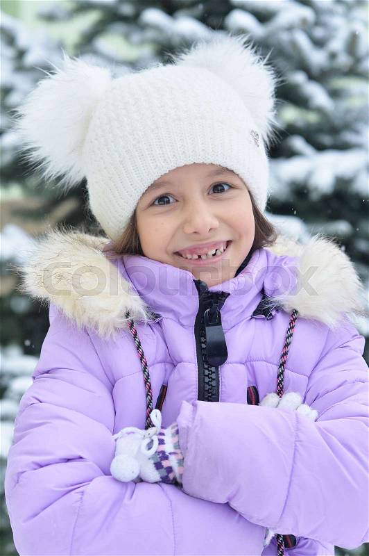 Happy smiling little girl posing outdoor in winter, stock photo