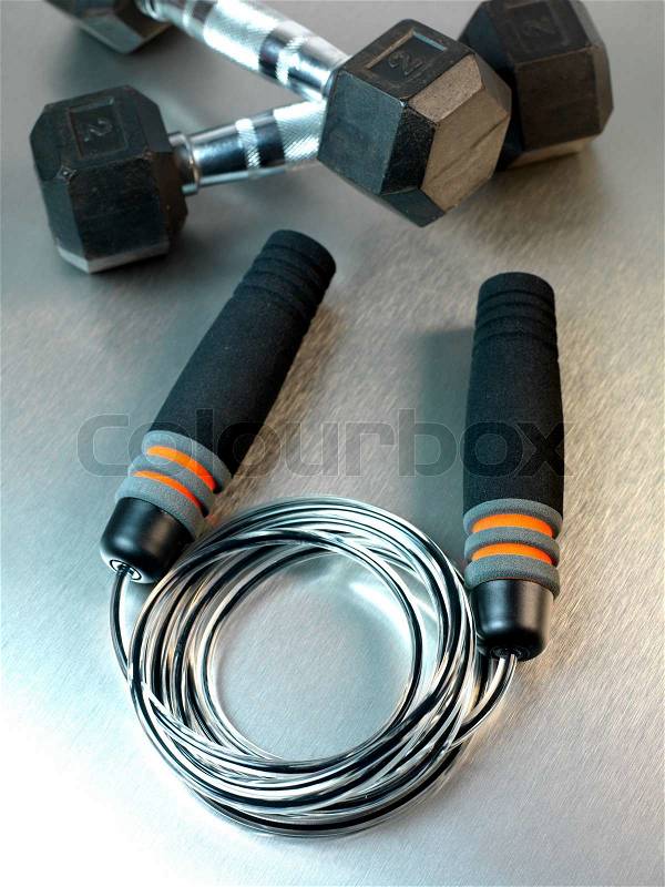 Gym sporting equipment on metalic background, stock photo
