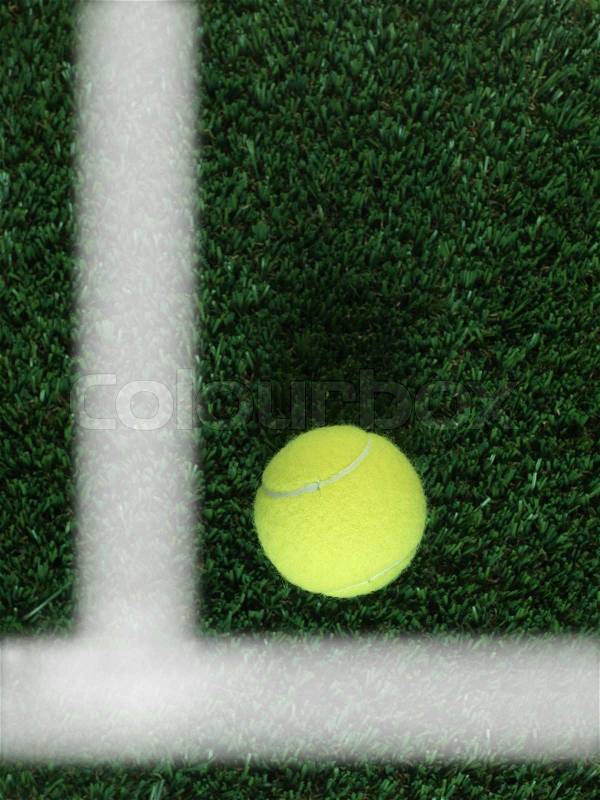 Sporting tennis balls on artificial green grass, stock photo