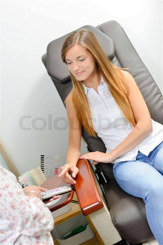 Getting her nails done, stock photo