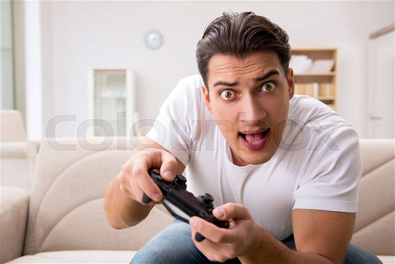 Man addicted to computer games, stock photo