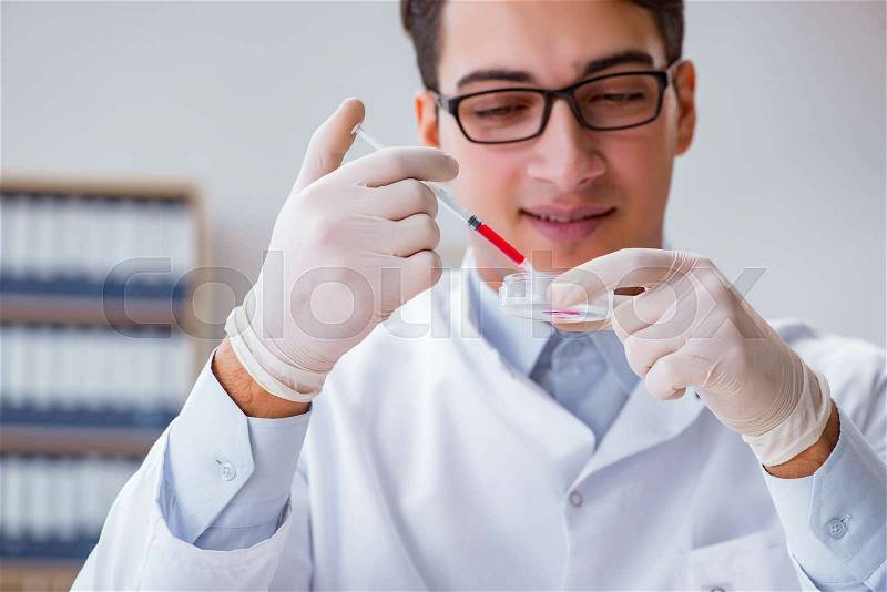 Young doctor with the syringe, stock photo