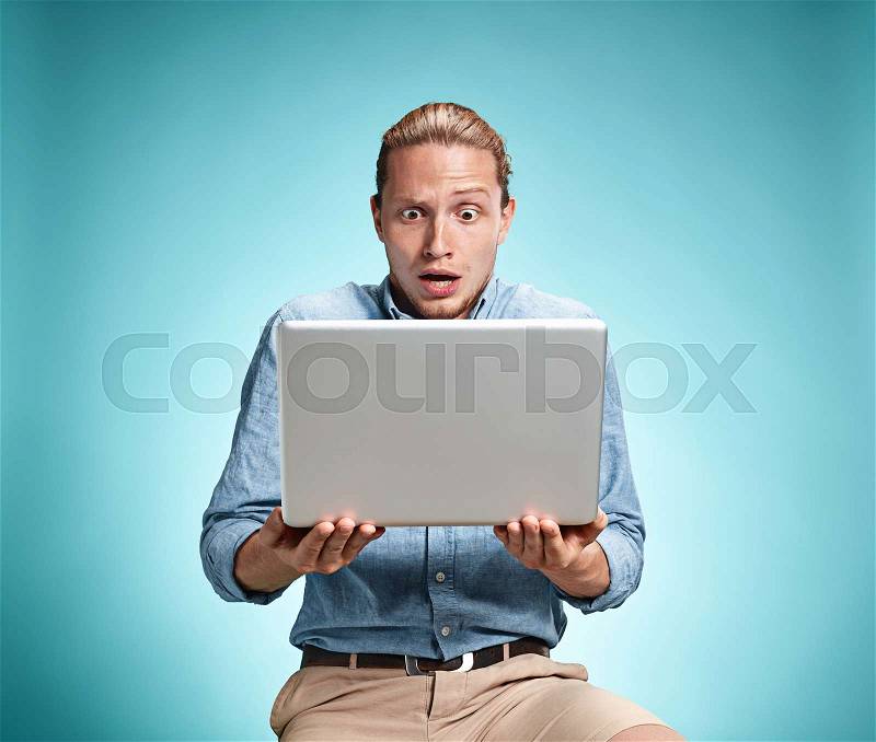 Sad Young Man Working On Laptop, stock photo