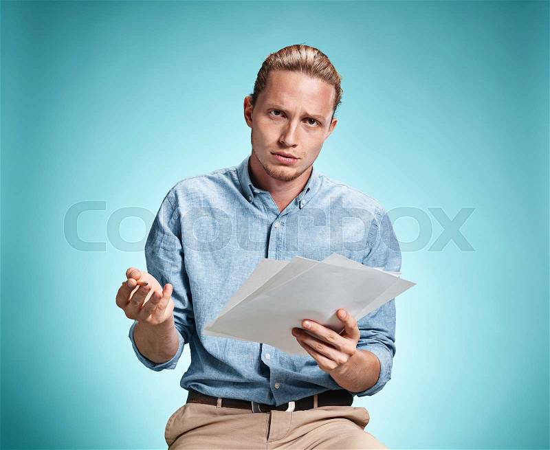 Smart sad student with sheets of paper, stock photo