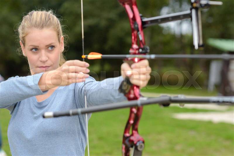 Woman doing archery, stock photo
