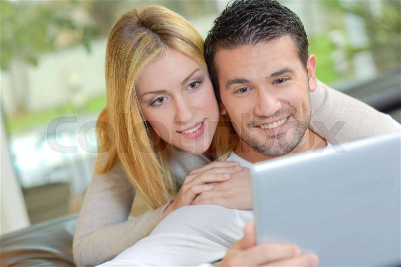 Couple looking at computer screen, stock photo