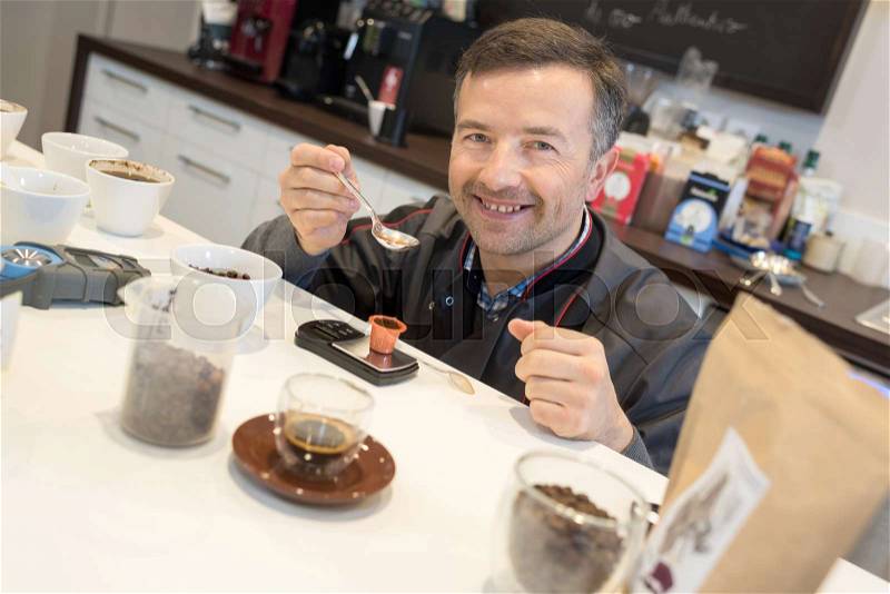 Man testing different types of coffee, stock photo