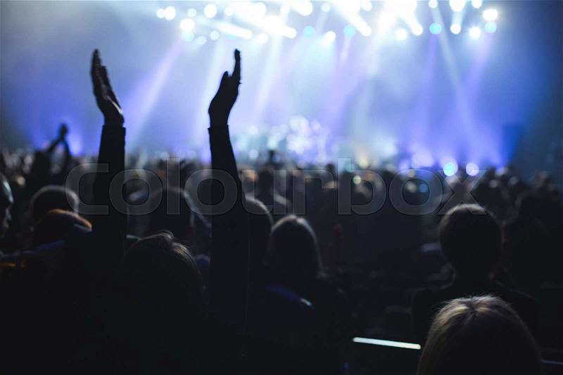The audience applauded by the stage artist. They shines the spotlight, stock photo
