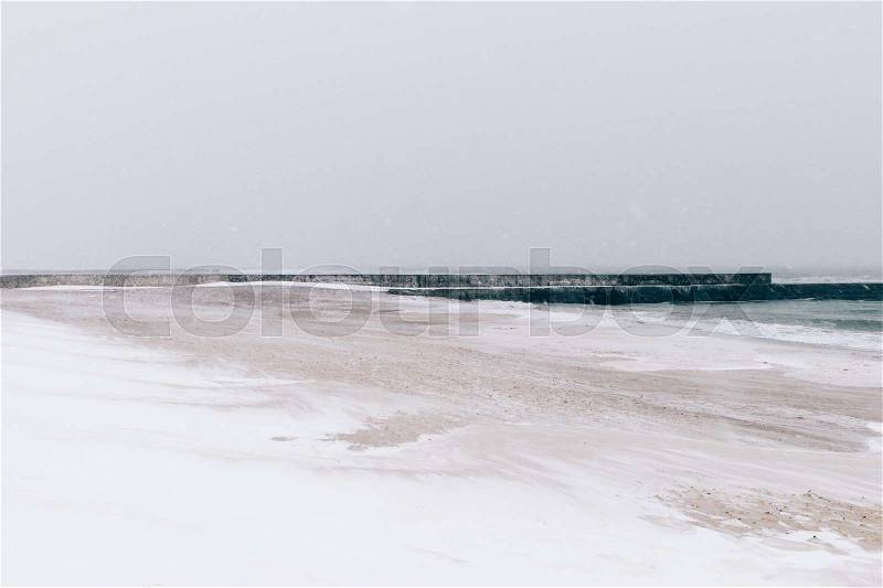 Beach during a blizzard and snowfall, minimalist landscape, soft focus, stock photo
