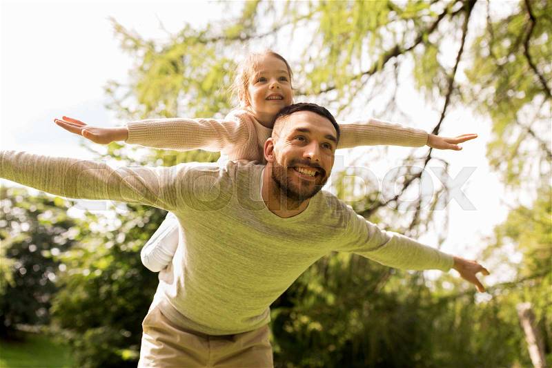 Family, parenthood, fatherhood and people concept - happy man and little girl in having fun in summer park, stock photo