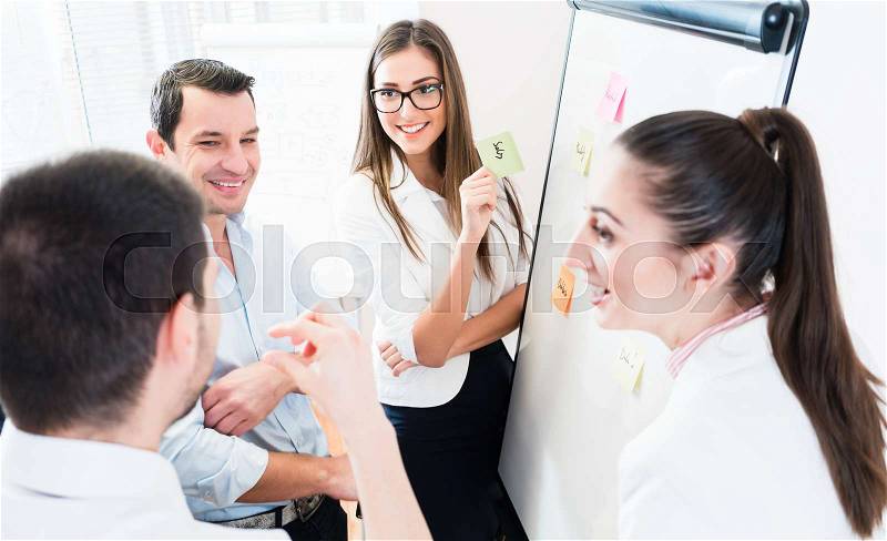 Sales Team at business meeting in office planning creative with sticky notes, stock photo