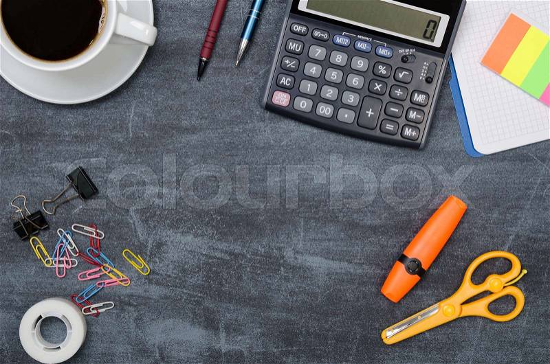 Business desk in office top view. Table with calculator, cup of coffee, notepad, and office supplies. Copy space website banner concept, stock photo