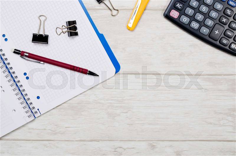 Business desk in office top view. Table with calculator, notepad, and office supplies. Copy space website banner concept, stock photo