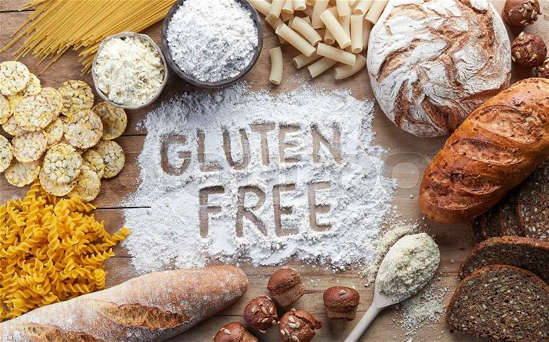 Gluten free food. Various pasta, bread, snacks and flour on wooden background from top view, stock photo
