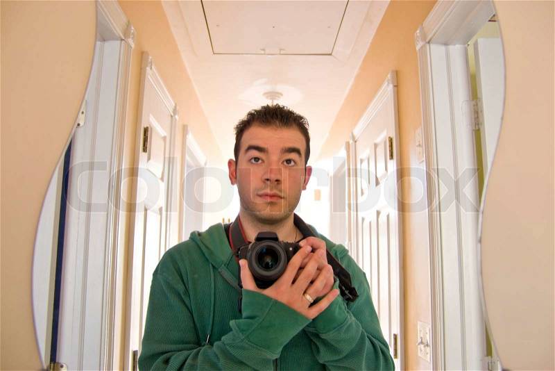 This is me - my self portraitI faced the curvy mirror at the end of the hallwayBacklit lighting coming from the other end of the house, stock photo