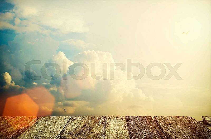 Cloud in the sky with wood table background at sunset. Nature background. Vintage filtered, stock photo