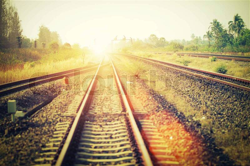 Soft focus of landscape of railroad tracks at train station in sunset. Vintage filtered, stock photo