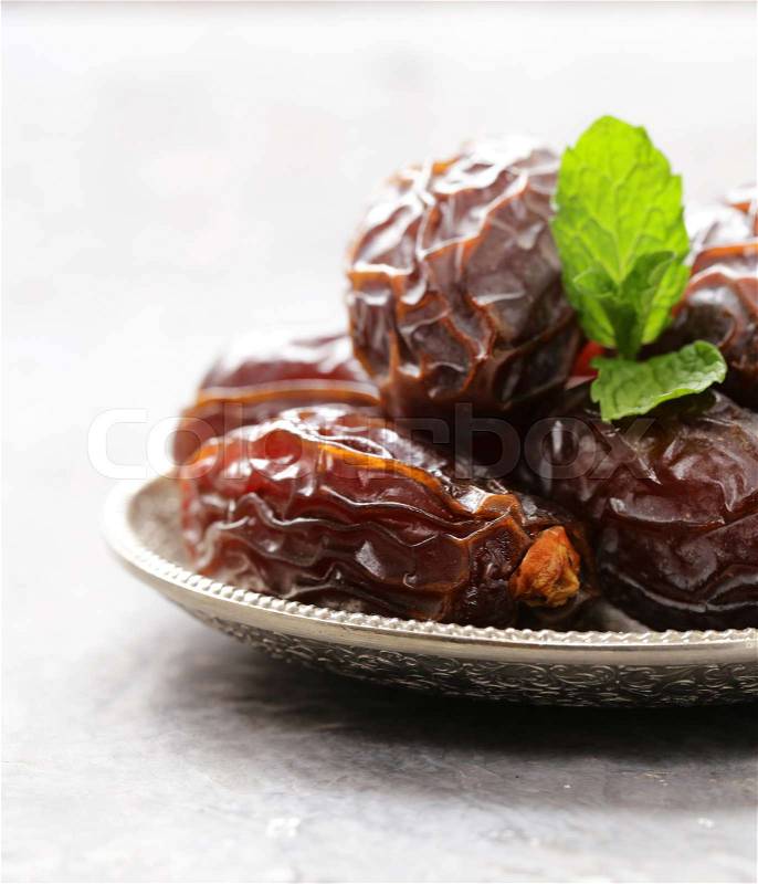 Sweet dried figs dates in a plate on the table, stock photo