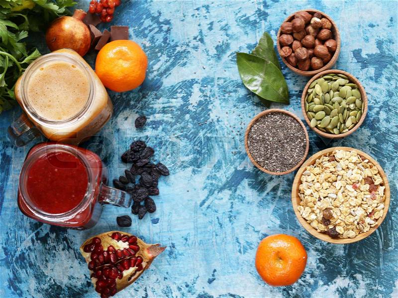 Still life super food - smoothies, muesli, nuts, berries, chia seeds, stock photo