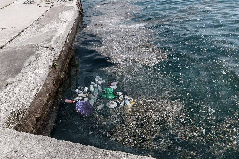 Garbage in water on pier. Danger ecology environment, stock photo