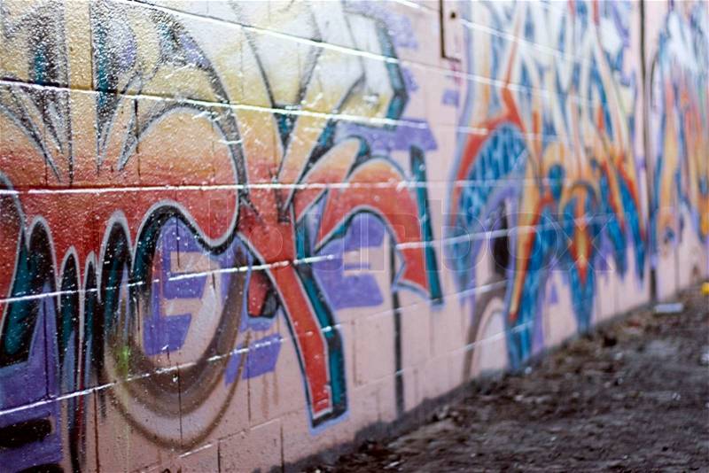 Colorful graffiti spray painted on a brick wall - makes a great background or backdropShallow depth of field, stock photo