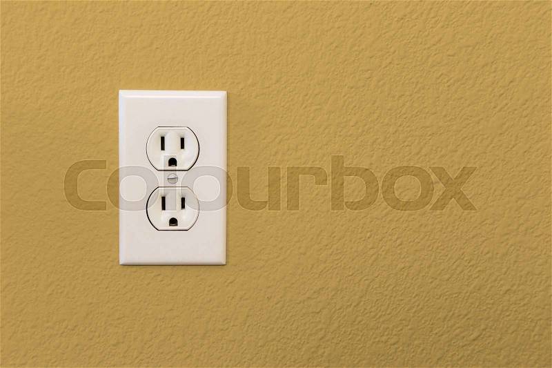 Electrical Sockets In Colorful Mustard Yellow Wall of House, stock photo