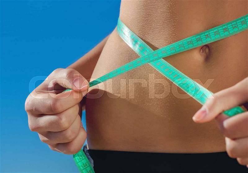 Sport girl measuring waist. Sports. Reducing excess weight. Healthy lifestyle, stock photo