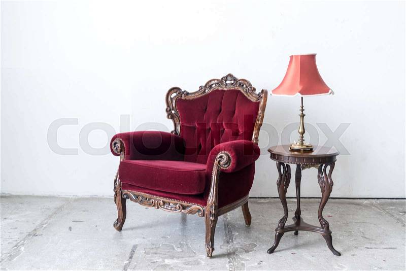 Red vintage sofa and lamp on white wall, stock photo