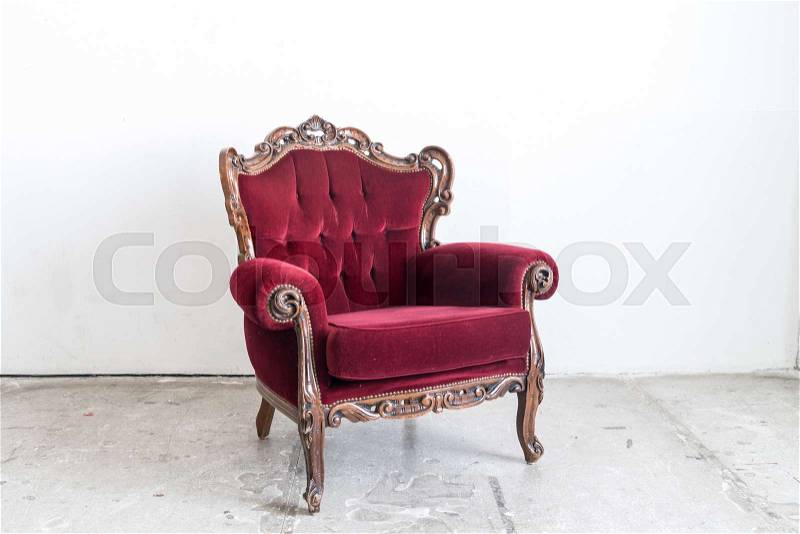 Red vintage sofa on white wall, stock photo