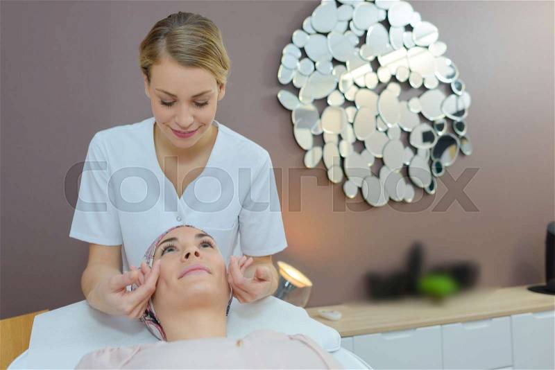 Young beautiful woman in spa environment taken care of, stock photo